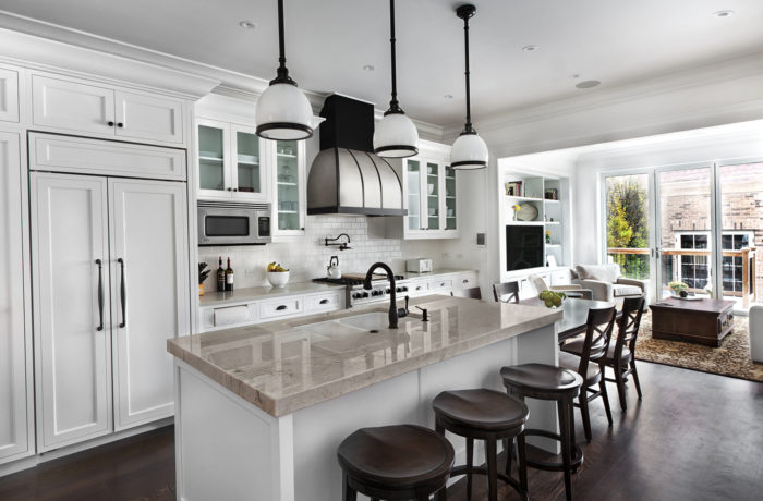 Transitional painted white kitchen and family room millwork